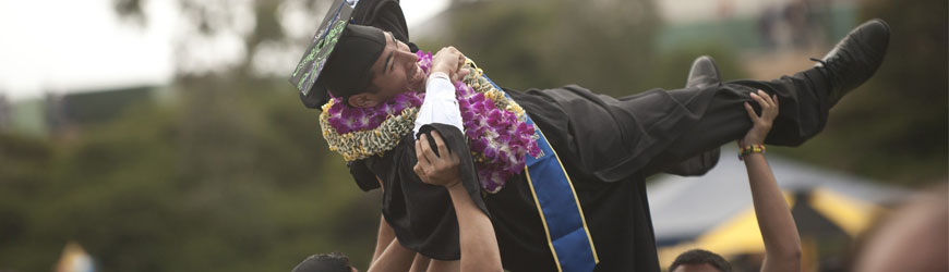 Graduate being lifted in air